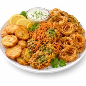MIX PAKORA (300g) : Une sélection de beignets indiens comme des rondelles d'oignon, des pakoras de légumes et des tranches de pommes de terre, garnis de citron et de coriandre, servis avec une sauce crémeuse.