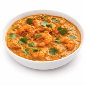 Un bol blanc de CREVETTES MADRAS (300g) présente un curry de crevettes orange crémeux, garni de feuilles de coriandre fraîches, sur fond blanc.